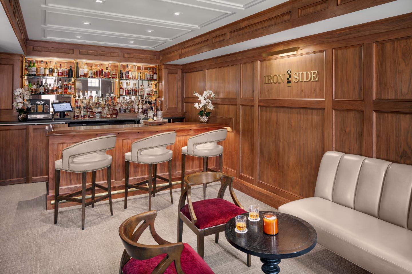 Cozy bar with elegant wooden paneling and plush seating.