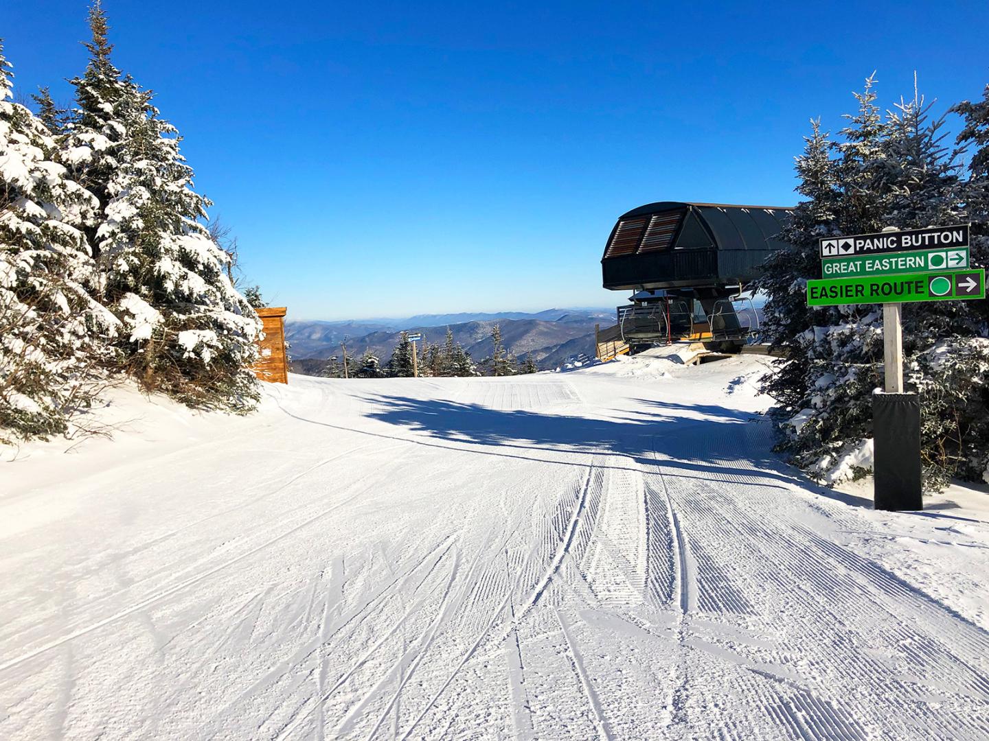 The top of a chairlift on a ski hill 